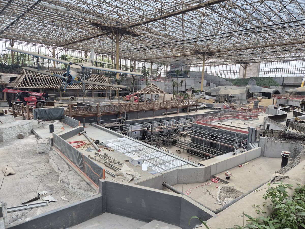 Immersive habitat under construction inside a large glass enclosure